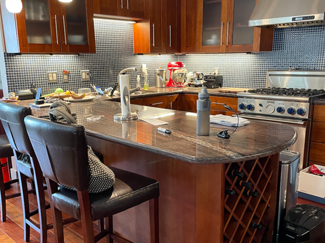 a kitchen with a center island and a wine rack.