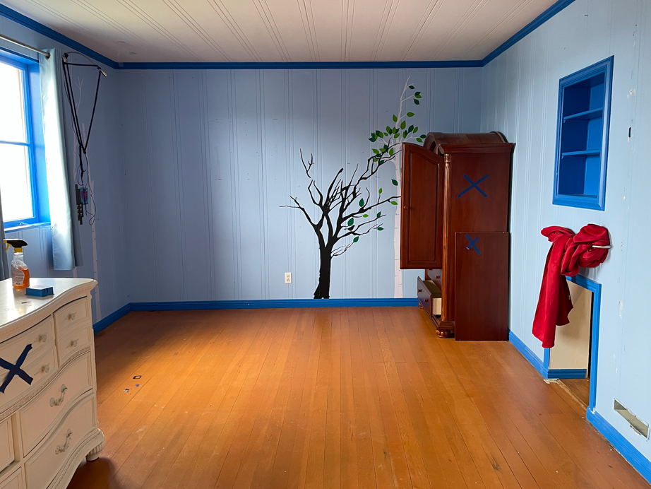 a room with blue walls and wooden floors.