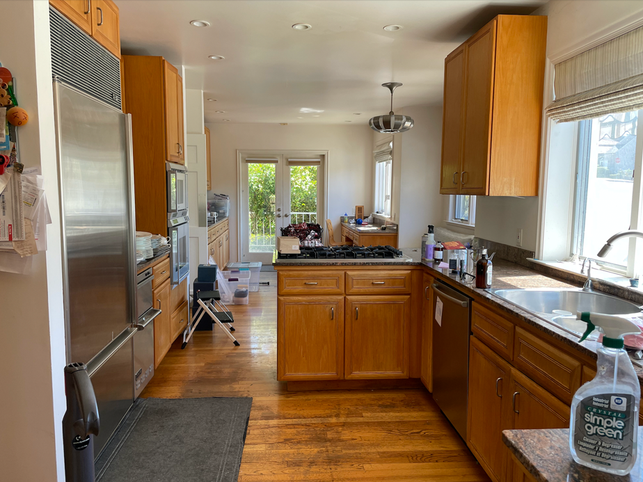 a kitchen with wooden cabinets and stainless steel appliances.